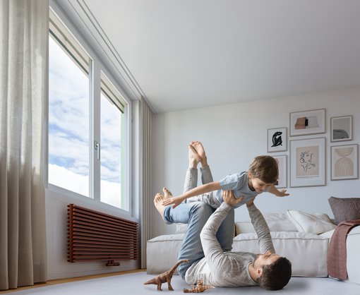 Happy young father lying on floor in living room hold fly with little preschooler son engaged in funny game together, loving dad relax playing with small boy child, enjoy family weekend at home, base iamge AdobeStock_332248000,
